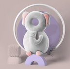 Gray elephant-shaped product on a purple stand with a circular white frame in the background
