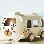 Toy car with a bear face design on a beach