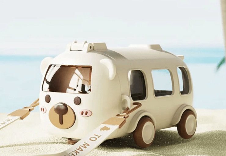 Toy car with a bear face design on a beach