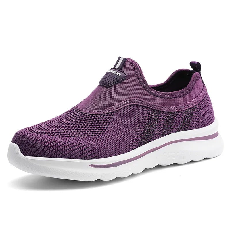 Purple sneaker with white sole on a white background