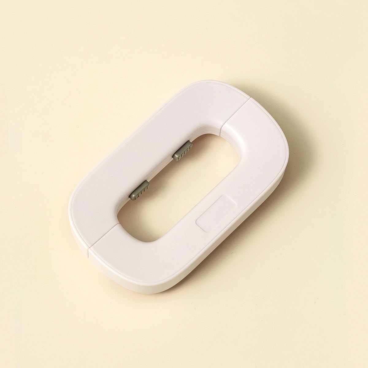 White electronic device on a beige background