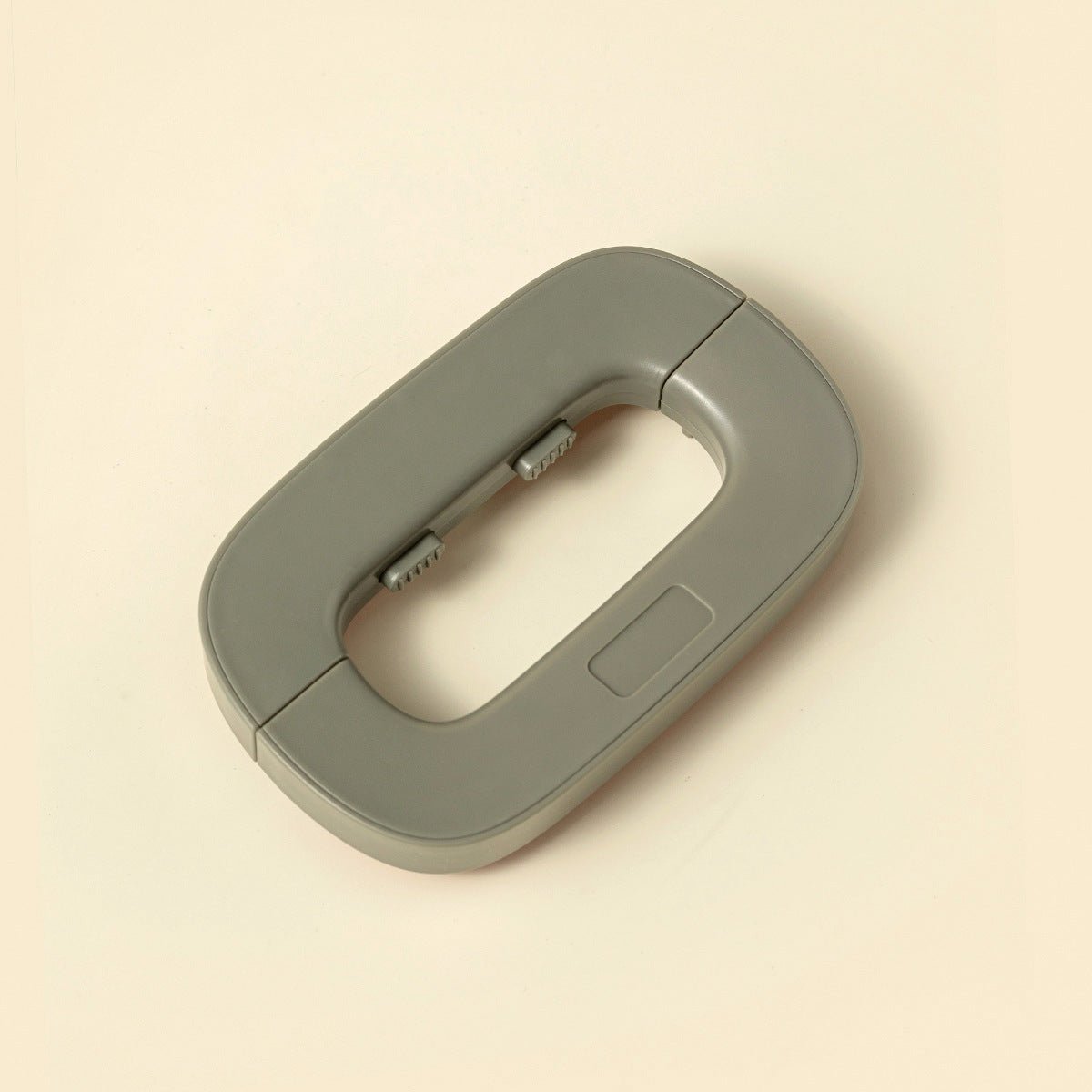 Gray plastic clip on a beige background