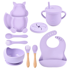 Purple baby feeding and dining set including cup, bowl, spoon, and bib on a white background