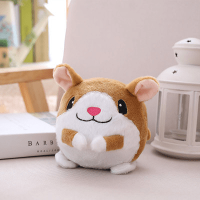 Plush toy resembling a hamster on a light surface with a blurred background