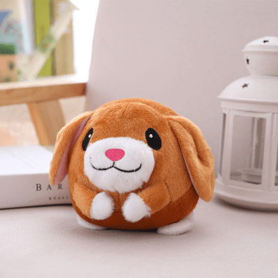 Plush toy dog with a pink nose on a light surface