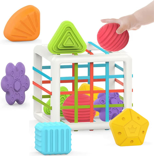 Colorful geometric shape sorting toy with a hand reaching for a red shape on a white background