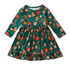Christmas-themed dress with gingerbread men, candy canes, and mugs on a green background