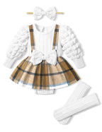 Children's outfit with white sweater, plaid skirt, white bow headband, and white tights on a white background