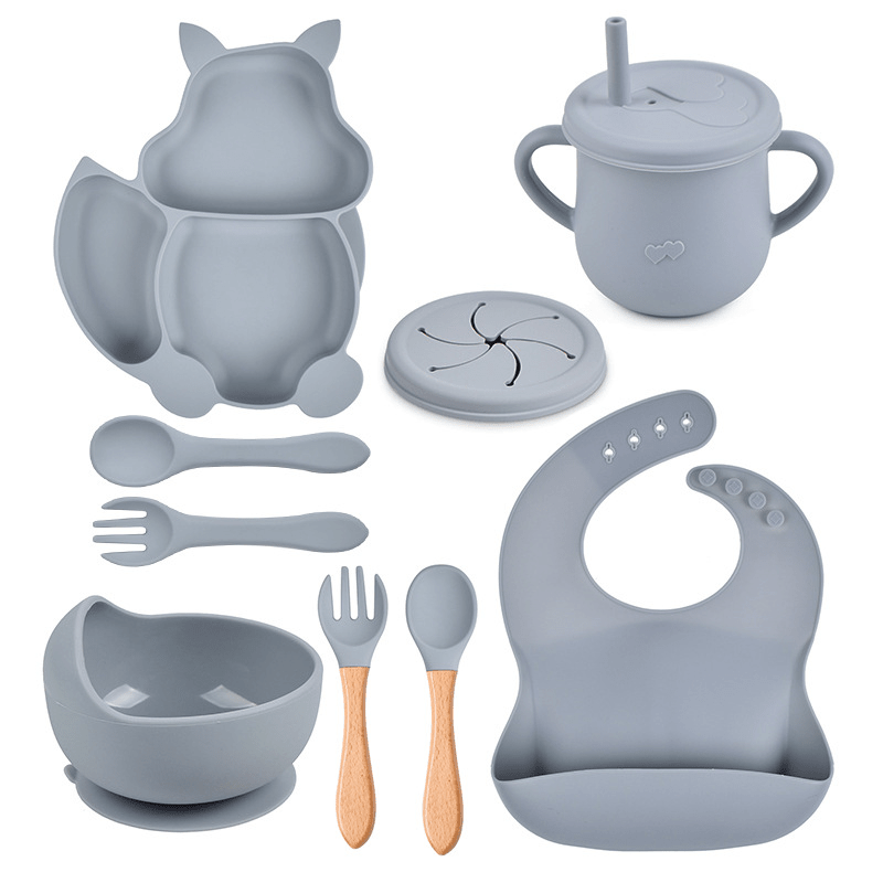 Collection of gray baby feeding utensils and accessories on a white background