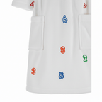 White coat with colorful numbers embroidered on a white background