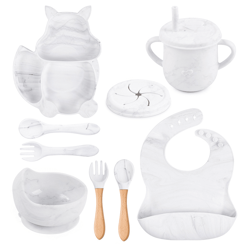 Collection of white baby utensils and accessories on a white background